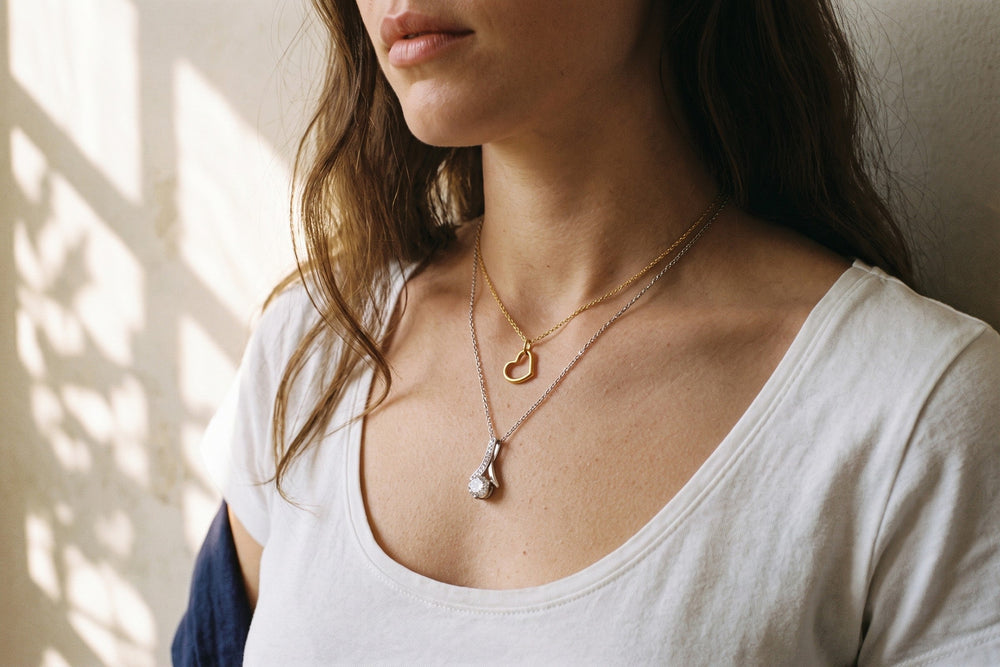 Two necklaces worn at different lengths on the neckline