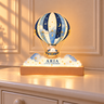 Aria Little Dreamer hot air balloon acrylic night light illuminated on an ivory nursery dresser