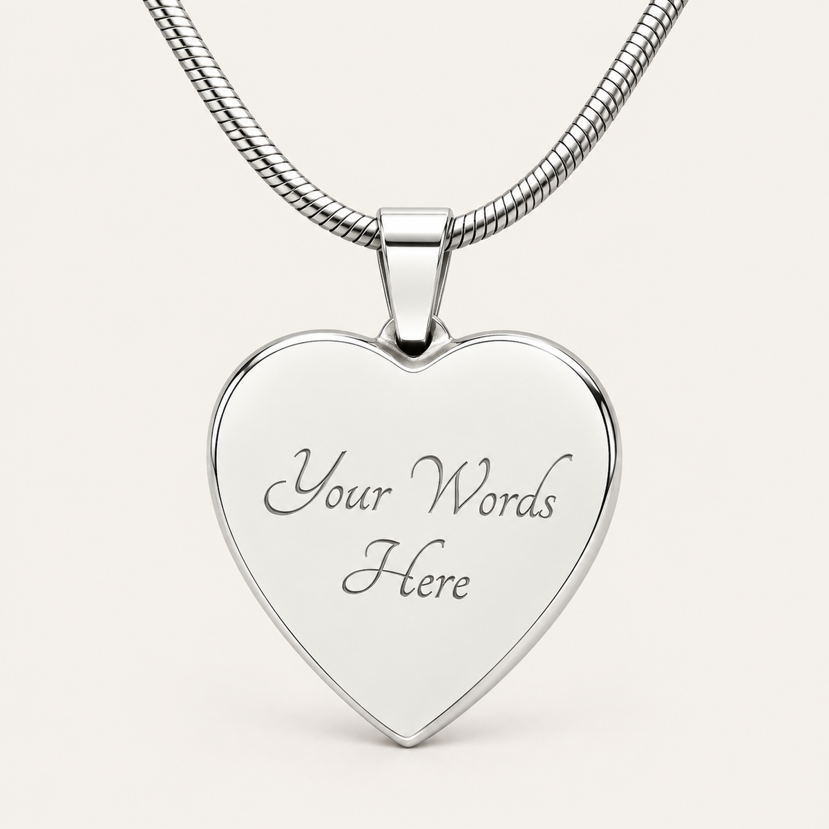 Back of a silver-tone heart map pendant showing the sample engraving Your Words Here.