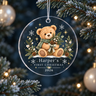 Clear acrylic first Christmas ornament with an evergreen-scarf teddy and example name Harper, hanging on a tree.