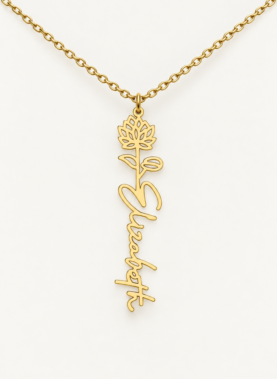 Gold-tone birth flower necklace with a carnation motif and vertical script name pendant on ivory.