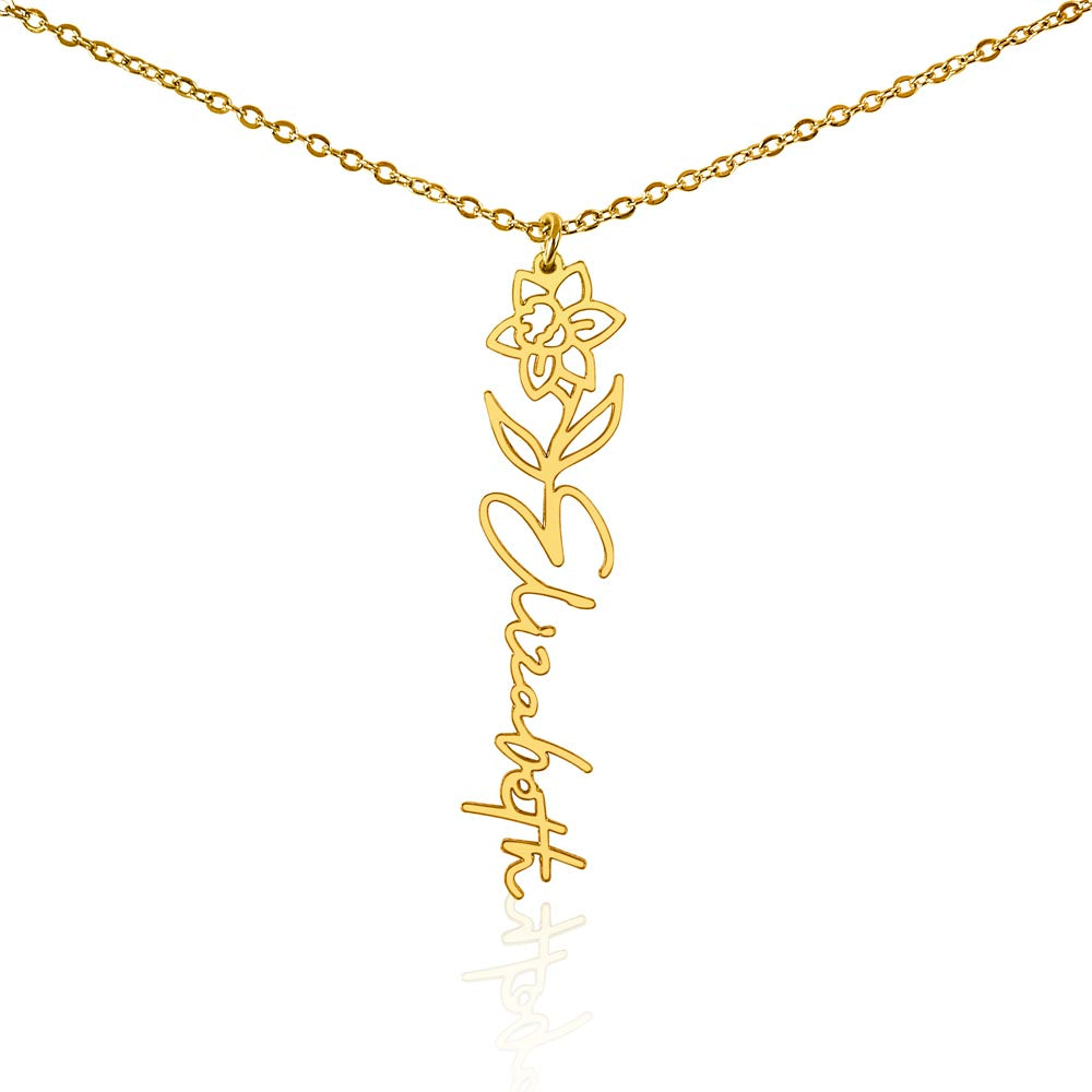 Gold-tone birth flower necklace with a iris motif and vertical script name pendant on white.