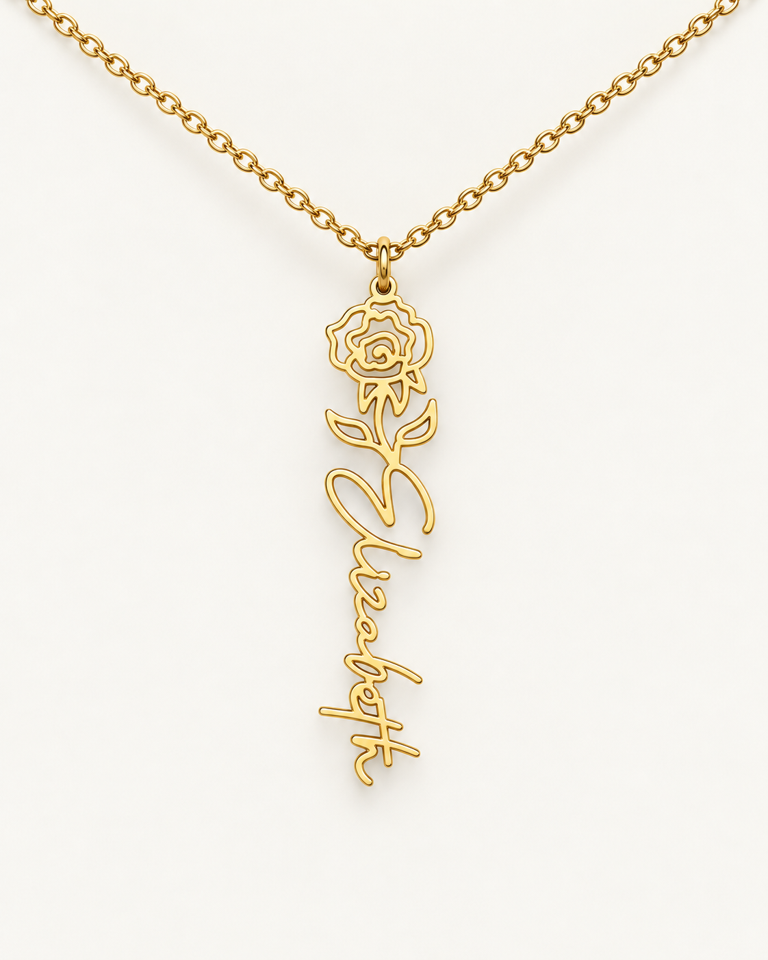 Gold-tone birth flower necklace with a marigold motif and vertical script name pendant on ivory.