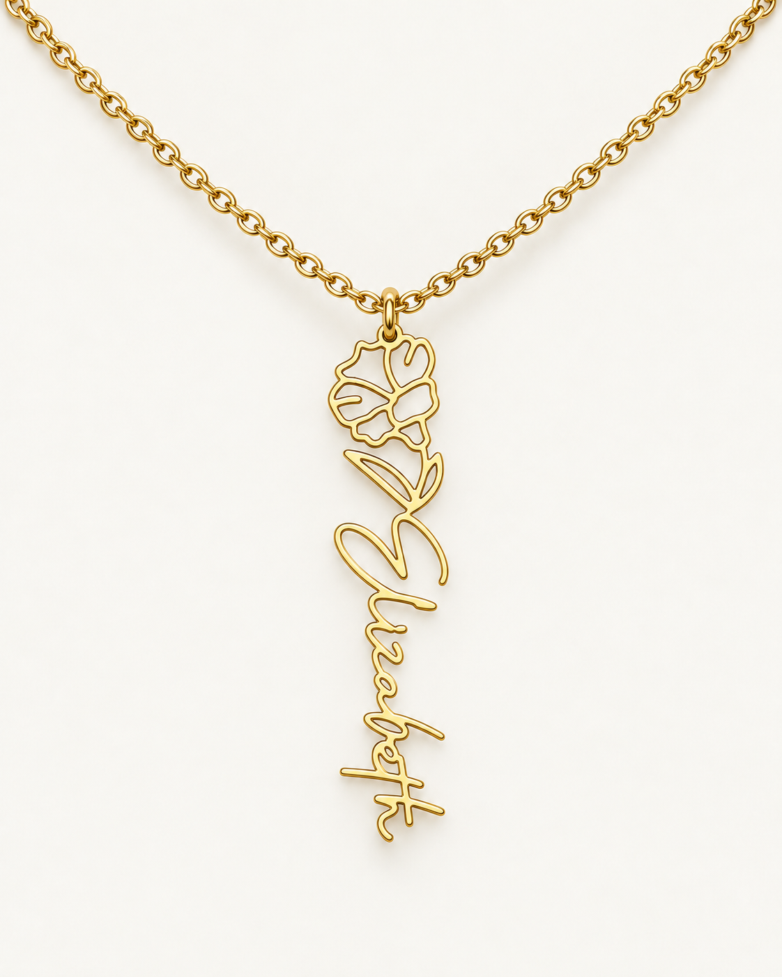 Gold-tone birth flower necklace with a morning glory motif and vertical script name pendant on ivory.