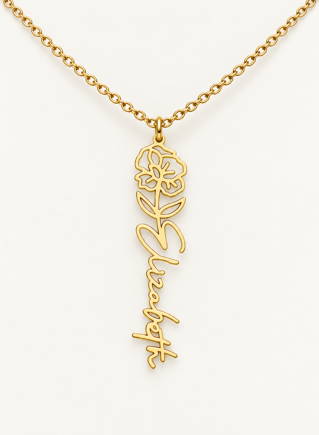 Gold-tone birth flower necklace with a poppy motif and vertical script name pendant on ivory.