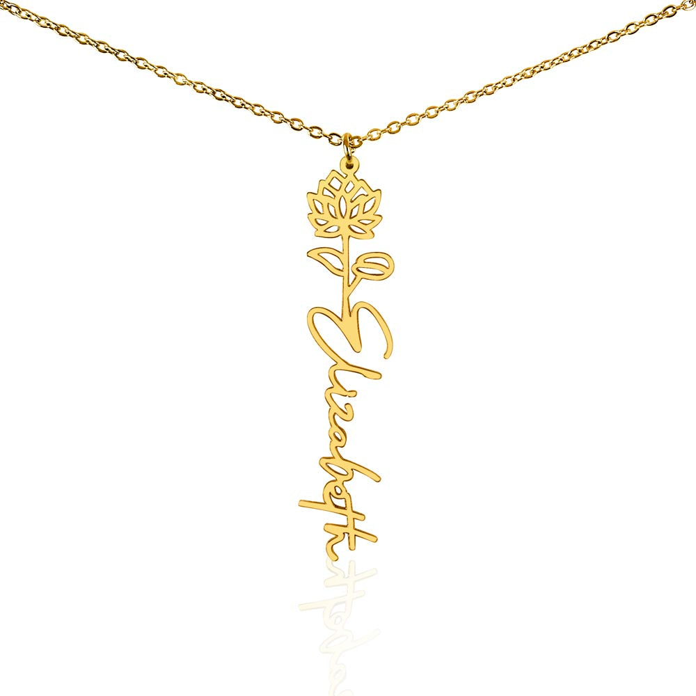 Gold-tone birth flower necklace with a water lily motif and vertical script name pendant on white.