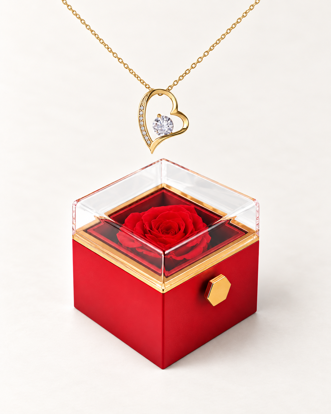 Gold-tone classic heart CZ necklace displayed above a red rotating rose gift box.