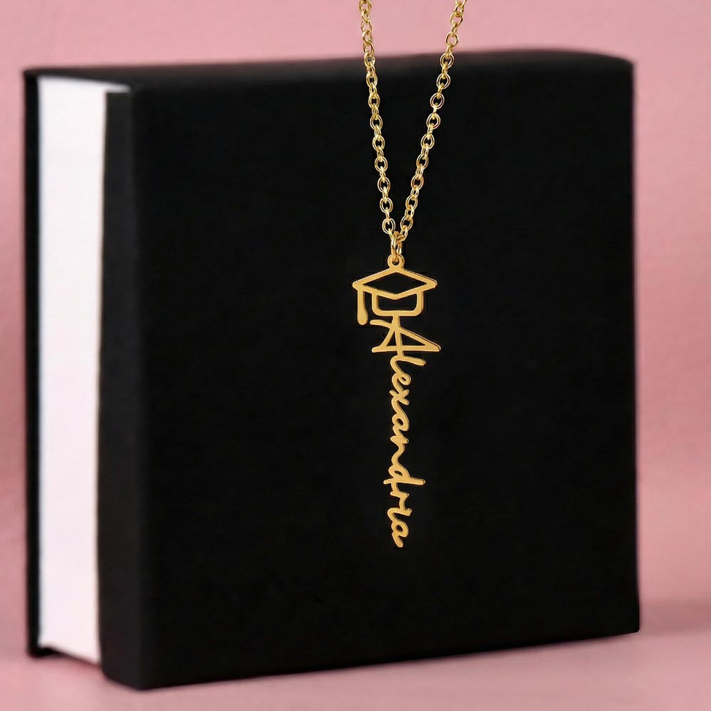 Gold-tone graduation name necklace displayed on a black gift box.