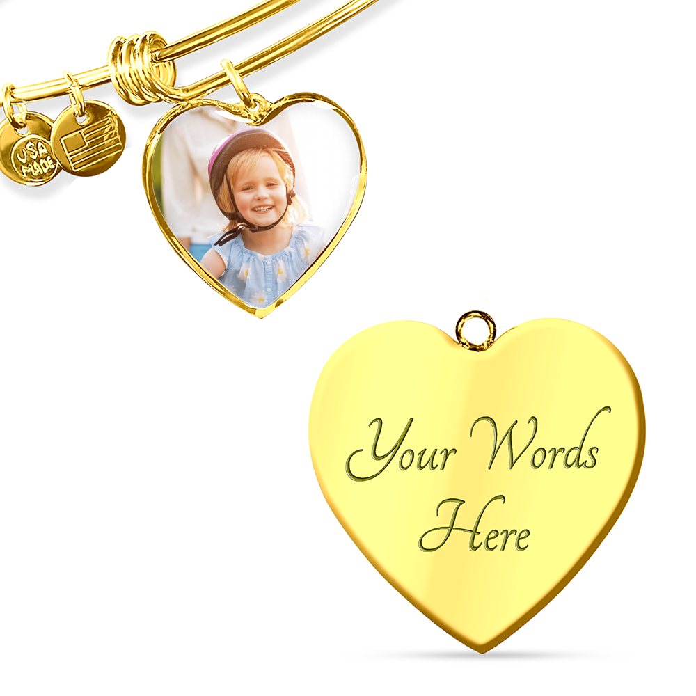 Close-up of a gold-tone heart photo charm and its reverse engraving area.