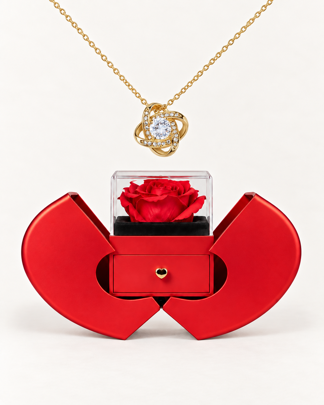 Gold-tone Love Knot CZ necklace displayed above an open red heart-shaped rose gift box.
