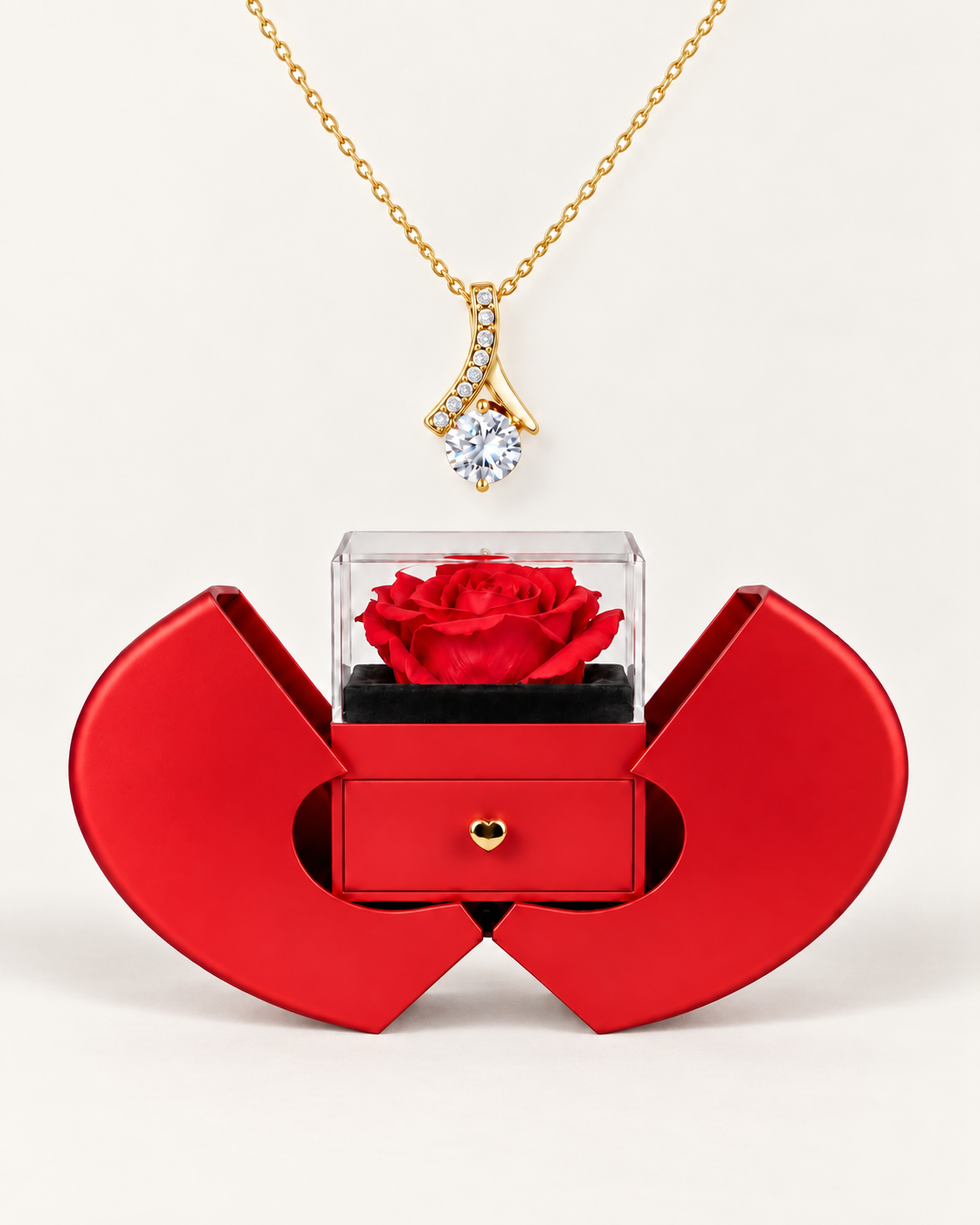 Gold-tone ribbon CZ necklace displayed above an open red heart-shaped rose gift box.