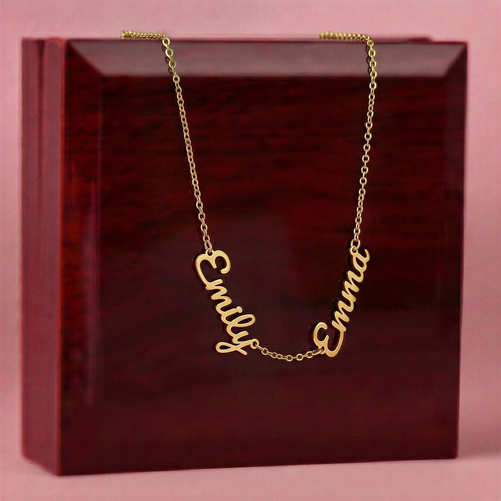 Gold-tone two-name necklace displayed on a wooden gift box.