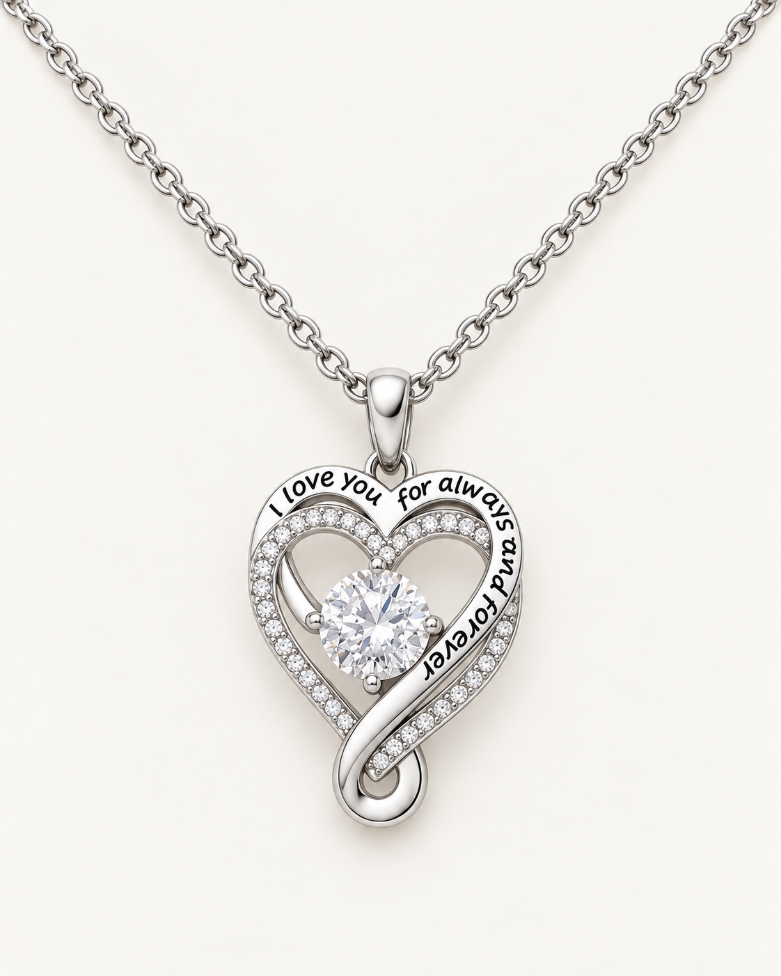 Close-up of the Love You Always heart pendant with its engraved message and CZ center stone.