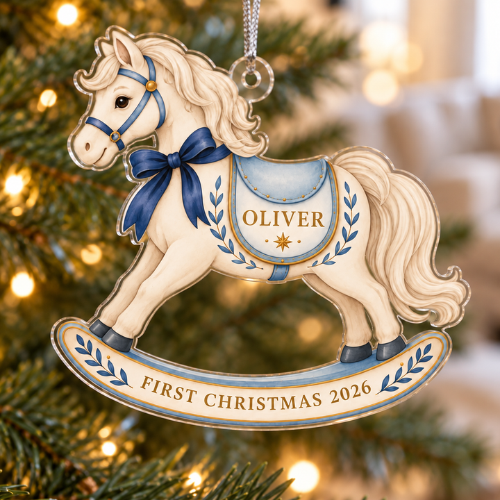 Personalized First Christmas 2026 rocking horse acrylic ornament hanging on a softly lit Christmas tree, with Oliver as a sample name.