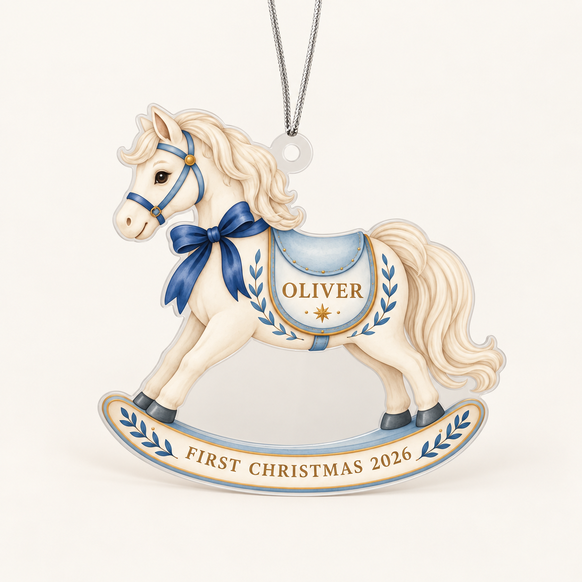Personalized blue and cream First Christmas 2026 rocking horse acrylic ornament on ivory, with Oliver shown as the sample name.