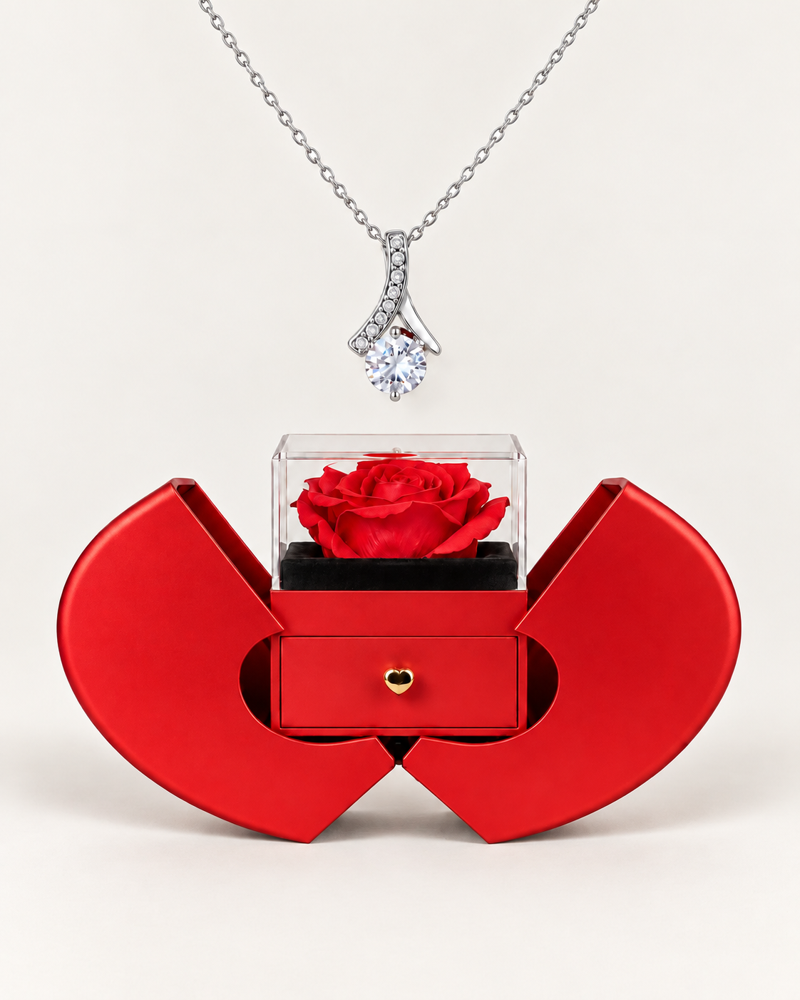 Silver-tone ribbon CZ necklace displayed above an open red heart-shaped rose gift box.