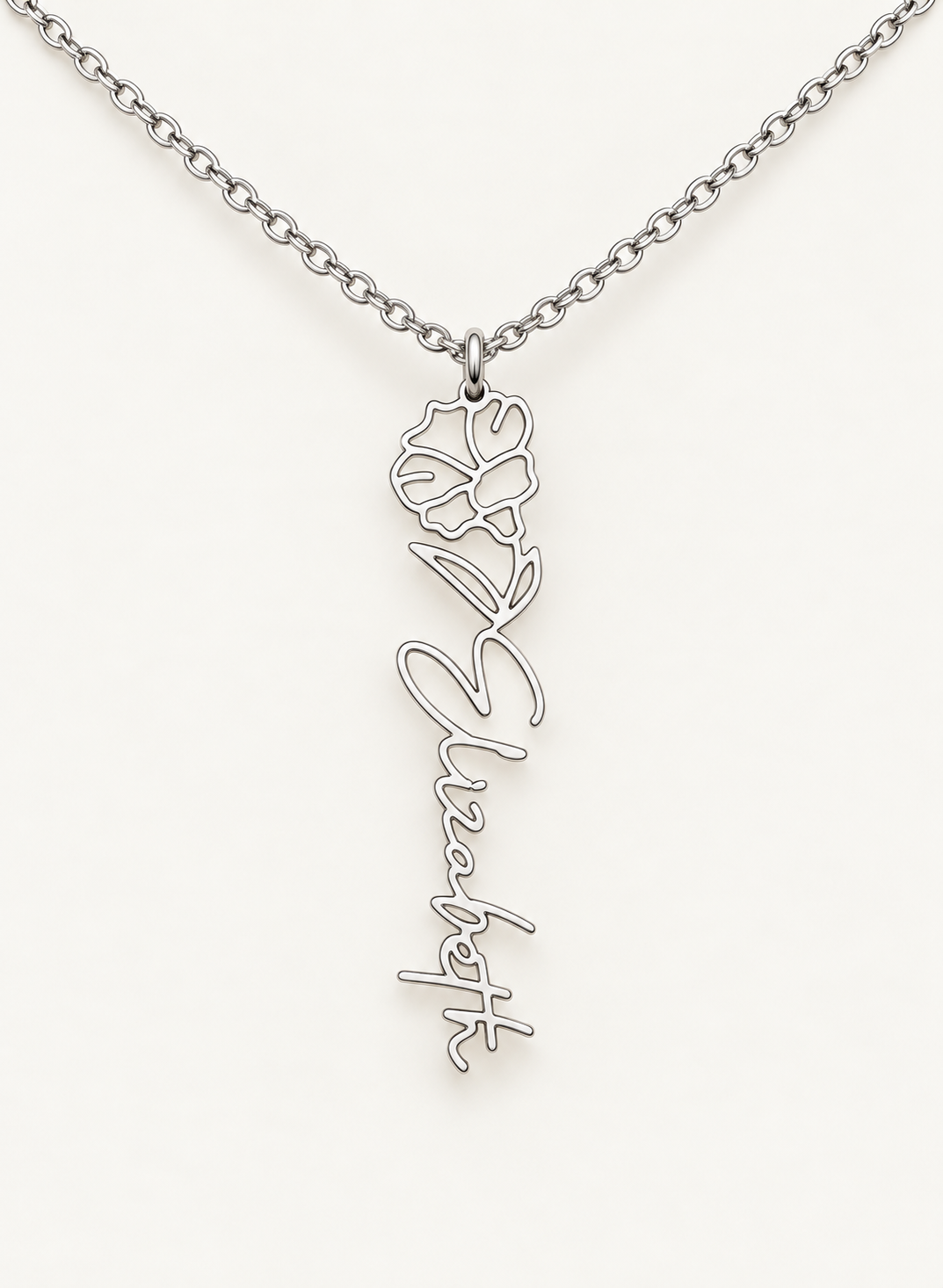 Silver-tone birth flower necklace with a morning glory motif and vertical script name pendant on ivory.