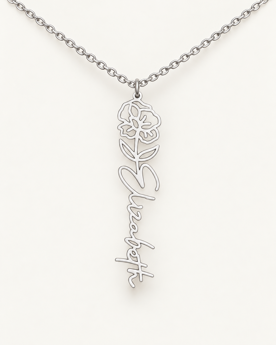 Silver-tone birth flower necklace with a poppy motif and vertical script name pendant on ivory.