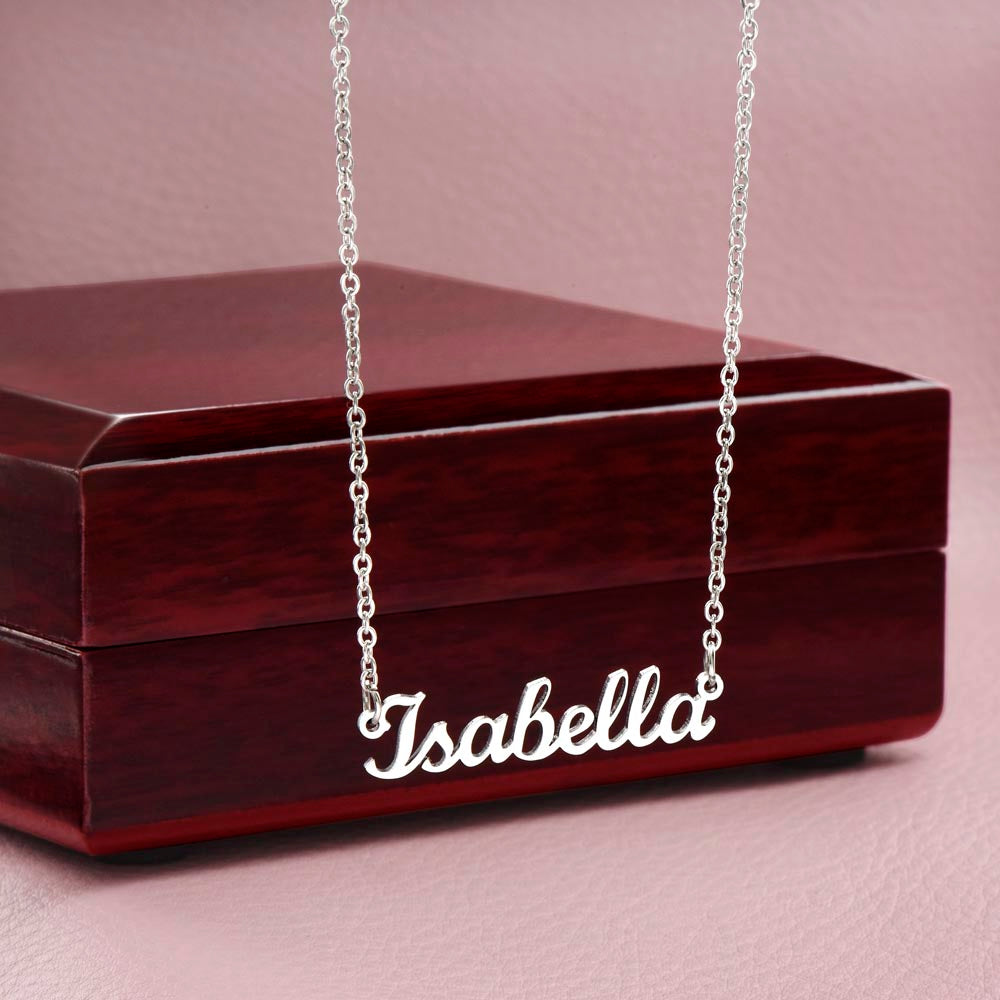 Silver-tone Isabella script name necklace displayed against a wooden gift box.