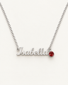 Silver-tone Isabella script name necklace with a red birthstone accent on ivory.
