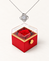 Silver-tone Love Knot CZ necklace displayed above a red rotating rose gift box.