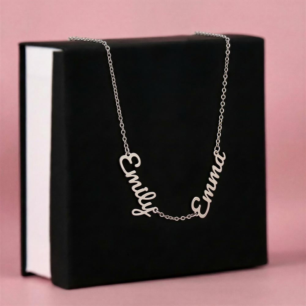 Silver-tone two-name necklace displayed on a black gift box.