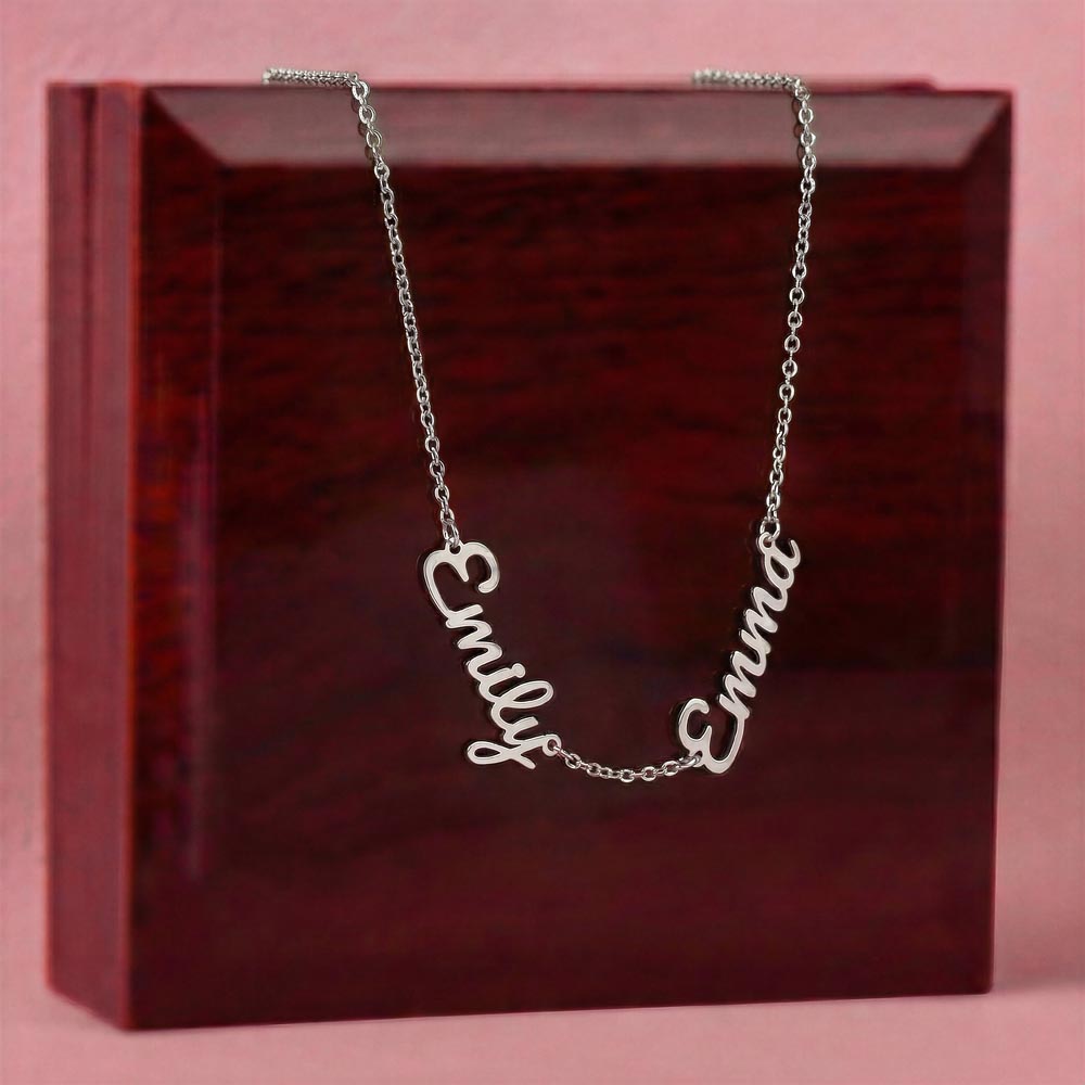 Silver-tone two-name necklace displayed on a wooden gift box.