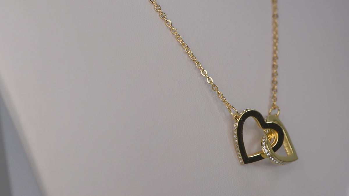 Product video showing the interlocking hearts pendant necklace.