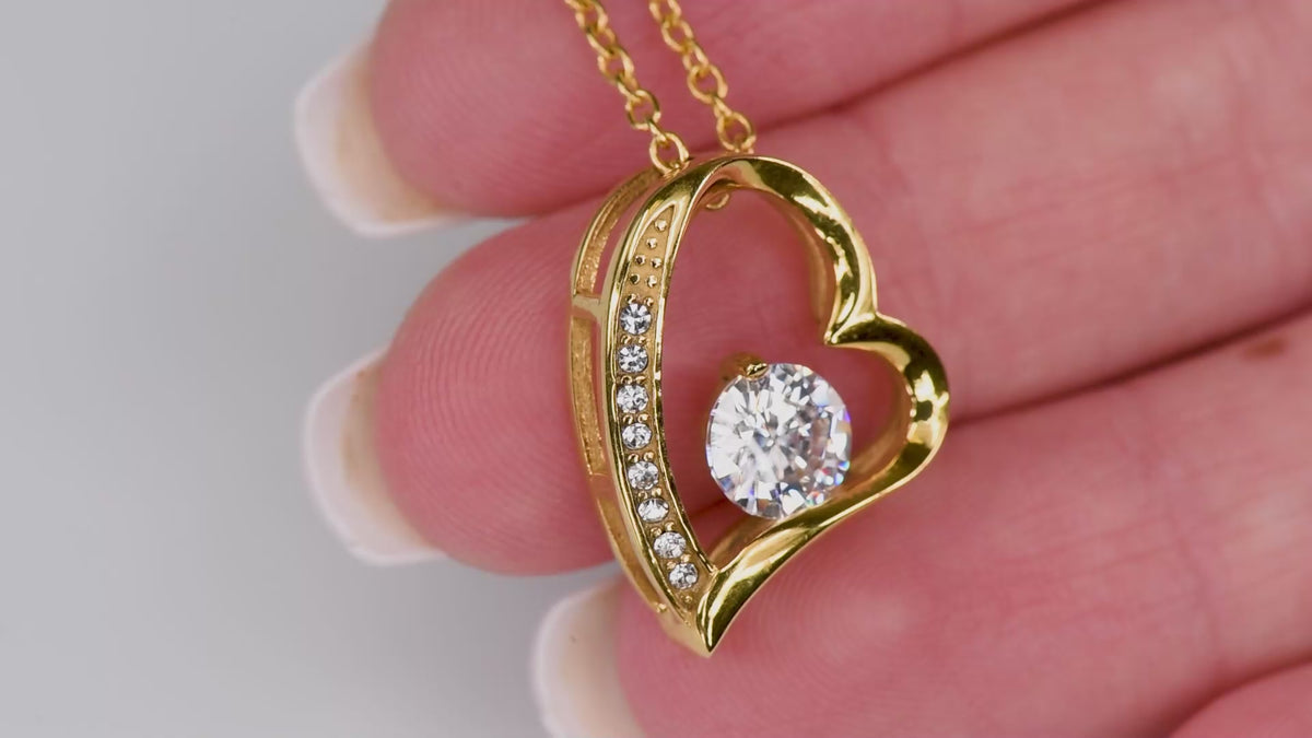 Product video showing the gold-tone classic heart CZ pendant against a hand.