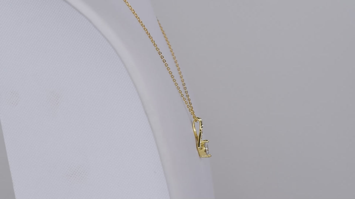 Product video of the gold-tone ribbon CZ necklace.